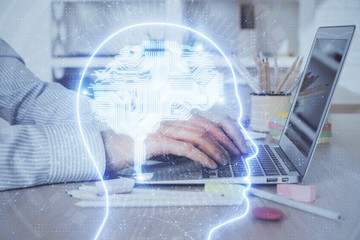 Man typing on keyboard background with brain hologram. Concept of big Data. Double exposure.