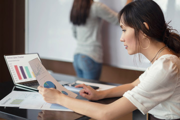 Obraz premium Serious focused corporate, Asian businesswoman working plan with looking documents try to resolving problem with discussion. Teamwork meeting