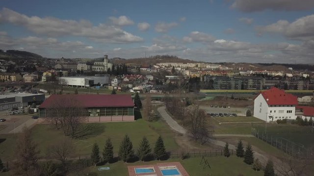 Gorlice, Poland - 4 5 2019: Panorama of the historic center of the European medieval city on the picturesque green hills. Trips to architectural monuments, temples, quarters and sports complex MOSiR