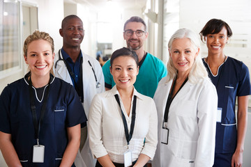 Portrait Of Medical Team Standing In Hospital Corridor - Powered by Adobe