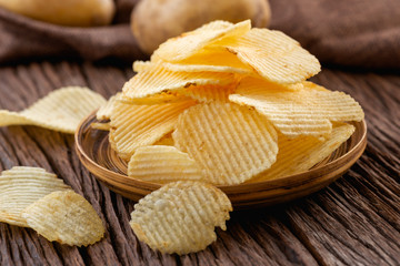 Appetizer and Snack food. Crispy potato chips on plate.