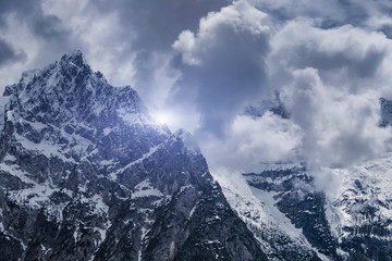 Fototapeta na wymiar Fantastic winter landscape. Dramatic overcast sky over Alps.