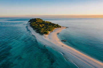 Epic aerial view of tropical island at sunset