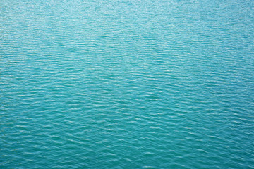 Blue rippled water as abstract background. Tranquil surface texture of the sea. Water ripples of a lake. Blue sea water in calm.