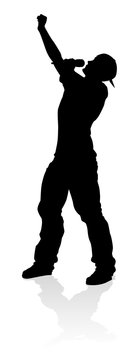 A singer pop, country music, rock star or hiphop rapper artist vocalist singing in silhouette