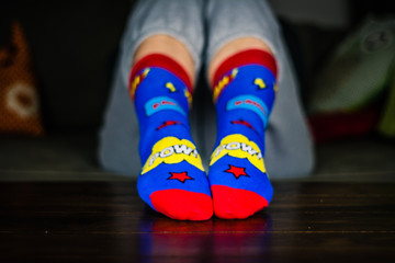 Woman sit and show colorful socks on her feet