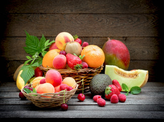 Healthy food, healthy eating - fresh organic fruit in wicker basket on rustic table