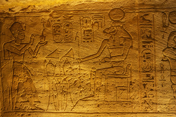 Fototapeta na wymiar Bas relief of the Pharaoh giving offerings in the Great Temple of Abu Simbel