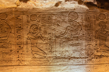 Bas relief of the Pharaoh kneeling before Horus in the Great Temple of Abu Simbel