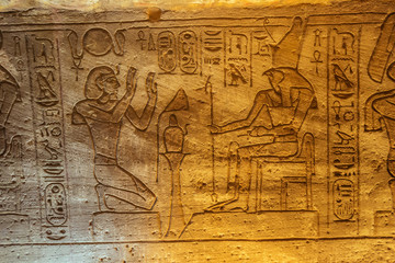 Fototapeta na wymiar Bas relief of the Ramesses II and Horus in the Great Temple of Abu Simbel