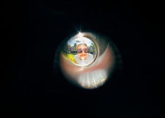 man looking from the door peephole 