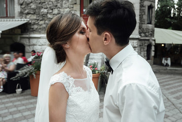 Stylish gorgeous happy bride and elegant groom performing their first dance at the wedding reception