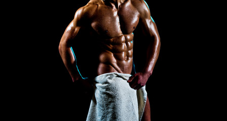 Mans health. Urologist. Attractive man covers manhood with a towel. - obrazy, fototapety, plakaty