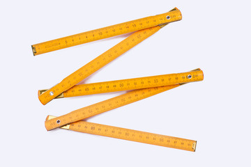 Yellow wooden ruler isolated on white background. Wooden centimeter ruler. Carpenters tool.