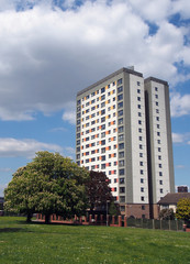 holbeck moor in leeds with with spring trees surrounded by housing on and a large public housing tower block meynell heights built in 1966 for leeds council