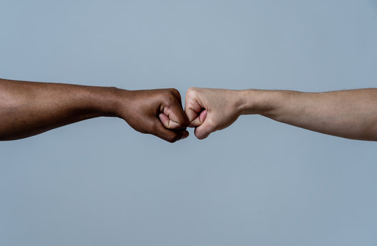 Fist Of Different Skin Colors Giving Fist Bump. Conceptual Image Of Race Tolerance And Stop Racism