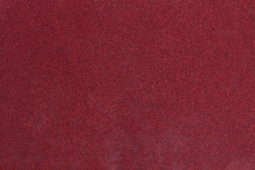 Fototapeta premium Red rough textured sandpaper background. Macro red sandpaper.