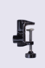 Black G-clamp isolated on white background. Vise clamp, vertical image.