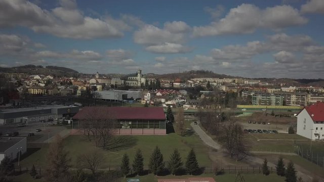 Gorlice, Poland - 4 5 2019: Panorama of the historic center of the European medieval city on the picturesque green hills. Trips to architectural monuments, temples, quarters and sports complex MOSiR