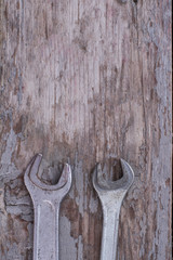 Steel wrenches and copy space. Stainless steel tools on rustic wooden background. Top view with text space.