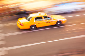 Fototapeta na wymiar Panning image of a Yellow Taxi cab in Times Square, New York City. New York. USA