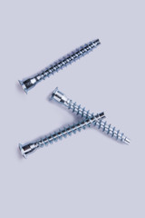 Screw nails isolated on white background. Three screws for construction, top view.