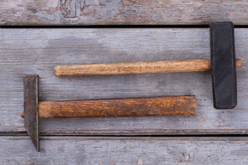 Two hammers on wooden background. Tools for construction or repair. Vintage style.
