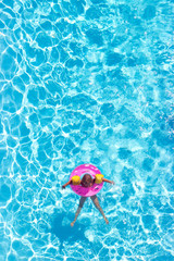 Aerial view of a little girl in the pool