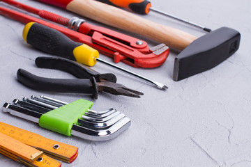 Set of construction tools. Folding ruler, allen key set, nippers, screwdriver, adjustable wrench and hammer. Space for text.