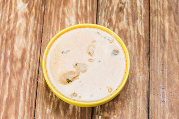 Fresh tasty soup with Asian curry and spices. Beautiful yellow soup dishes with fresh vegetables.