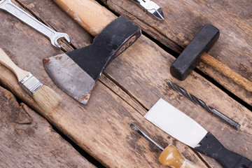 Various tools on rustic wooden planks. Old hand working tools on the rough wooden boards.