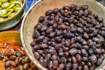 Marinated olives with herbs in a market.