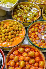 Marinated olives with herbs in a market.