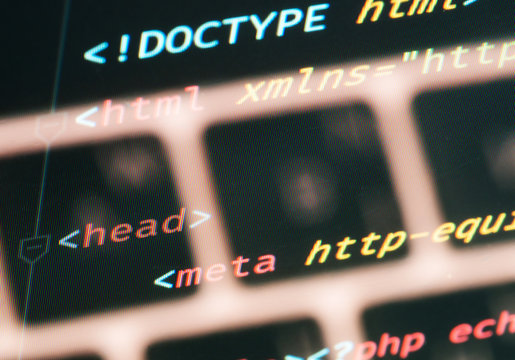 Html document code with keyboard close-up on the screen