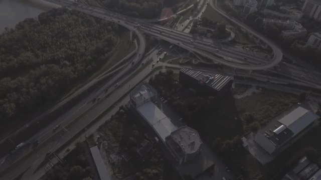 Top view downward of the drone shows an impressive highway elevation and the convergence of roads, bridges, viaducts in Warsaw during the day, the development of transport and infrastruc. 4K. RAW 