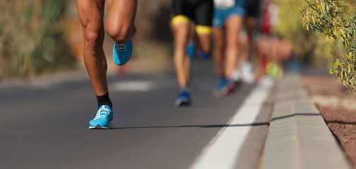 Marathon running race, people feet on city road