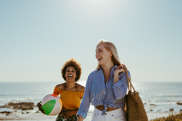 Female friends enjoying on beach vacation