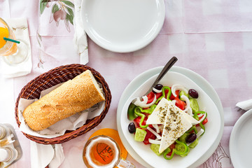 Greek salad with fresh vegetables, feta cheese and black olives, flat lay copy space