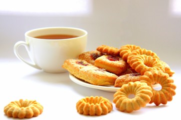  A variety of shaped cookies. White cup of tea. Morning is sweet. Tea ceremony.
