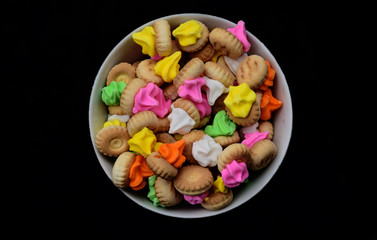 Colorful small bread snacks from Indonesia, these snacks taste very tasty and sweet. colorful little bread on a plate with a blank black background