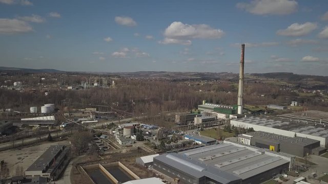 Gorlice, Poland - 3 9 2019: Industrial region of the Carpathian city. Top view of the refinery and auxiliary buildings. Video shot by drone or quadrocopter. Vanity of the day at the factory. Planning 