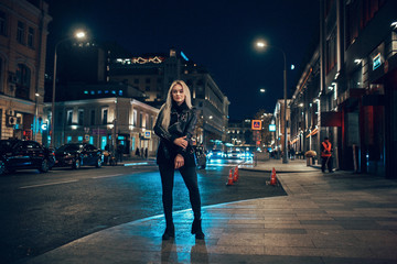 beauty woman posing over night illuminated street