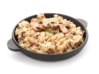 Frying pan with tasty risotto on white background