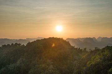 Beautiful tropical landscape with mountain rainforest and steep rocky ridge at horizon at sunset. Krabi, Thailand