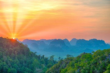 Fototapeta na wymiar Majestic landscape with dramatic sunset and silhouette of steep mountain ridge on horizon. HDR image