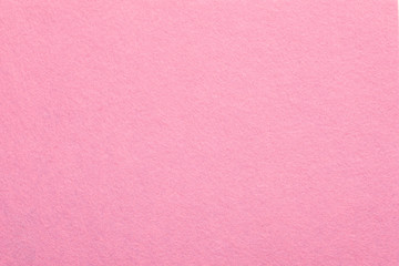 Sweet pink felt texture abstract art background. Colored fabric fibers surface. Empty space.