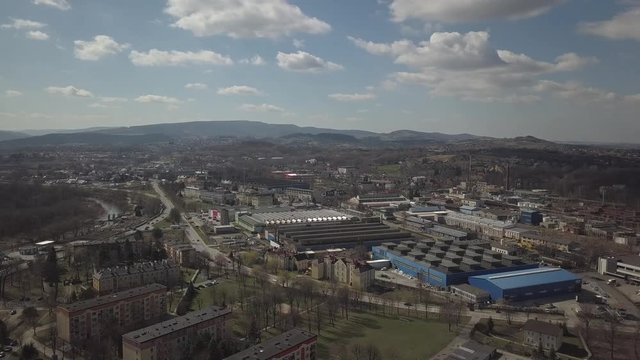 Gorlice, Poland - 3 9 2019: Industrial region of the Carpathian city. Top view of the refinery and auxiliary buildings. Video shot by drone or quadrocopter. Vanity of the day at the factory. Planning 