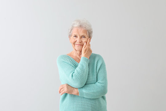 Portrait of senior woman on light background