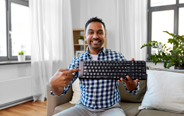 blogging, videoblog and people concept - indian male blogger recording video review of computer keyboard at home