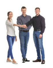 Group of young business people putting hands together on white background